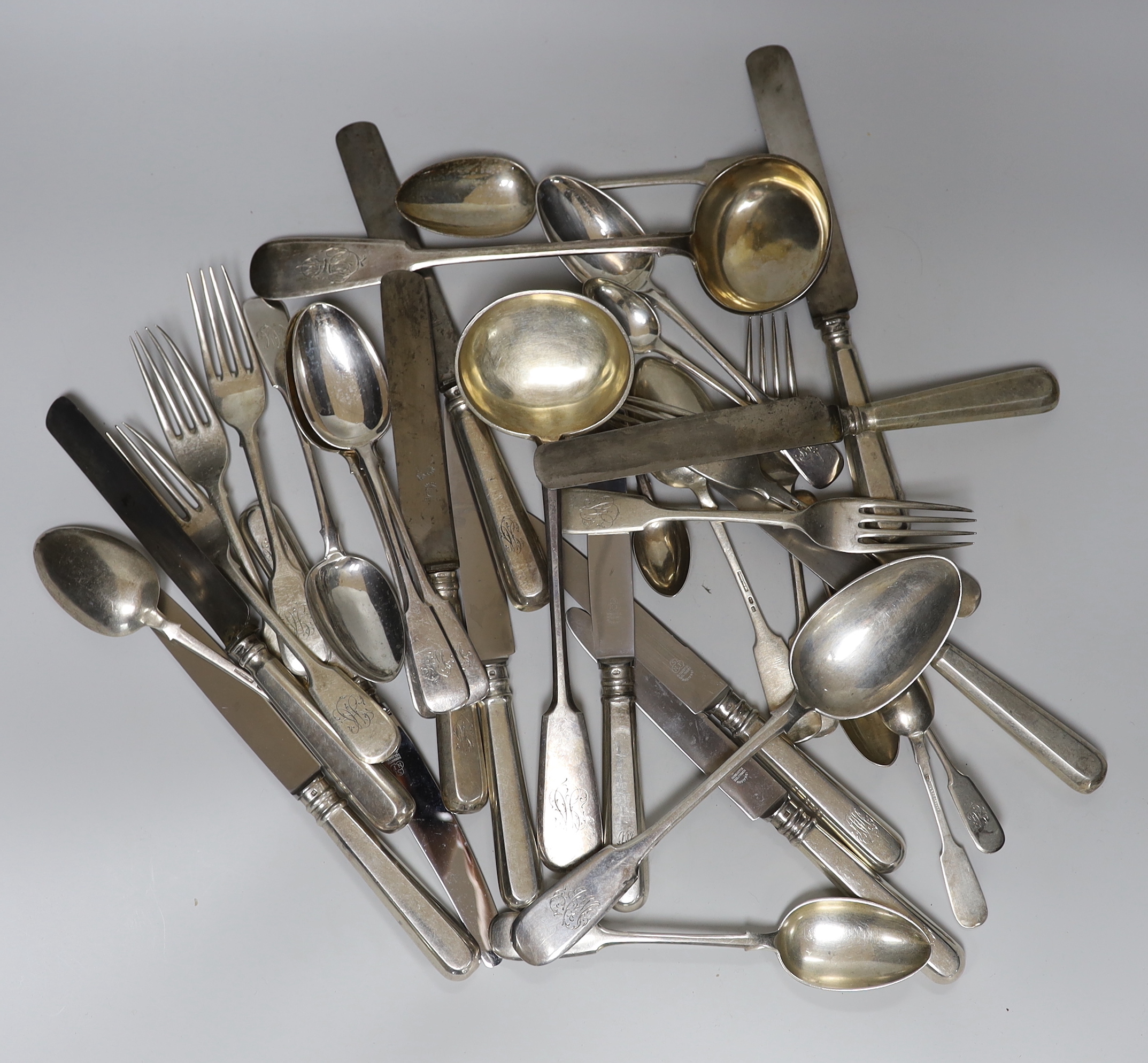 A part canteen of late 19th/early 20th century Russian 84 zolotnik fiddle pattern cutlery by T. Bomakapobon?, comprising nine tablespoons, twelve table forks, two soup ladles and eleven table knives with differing handle